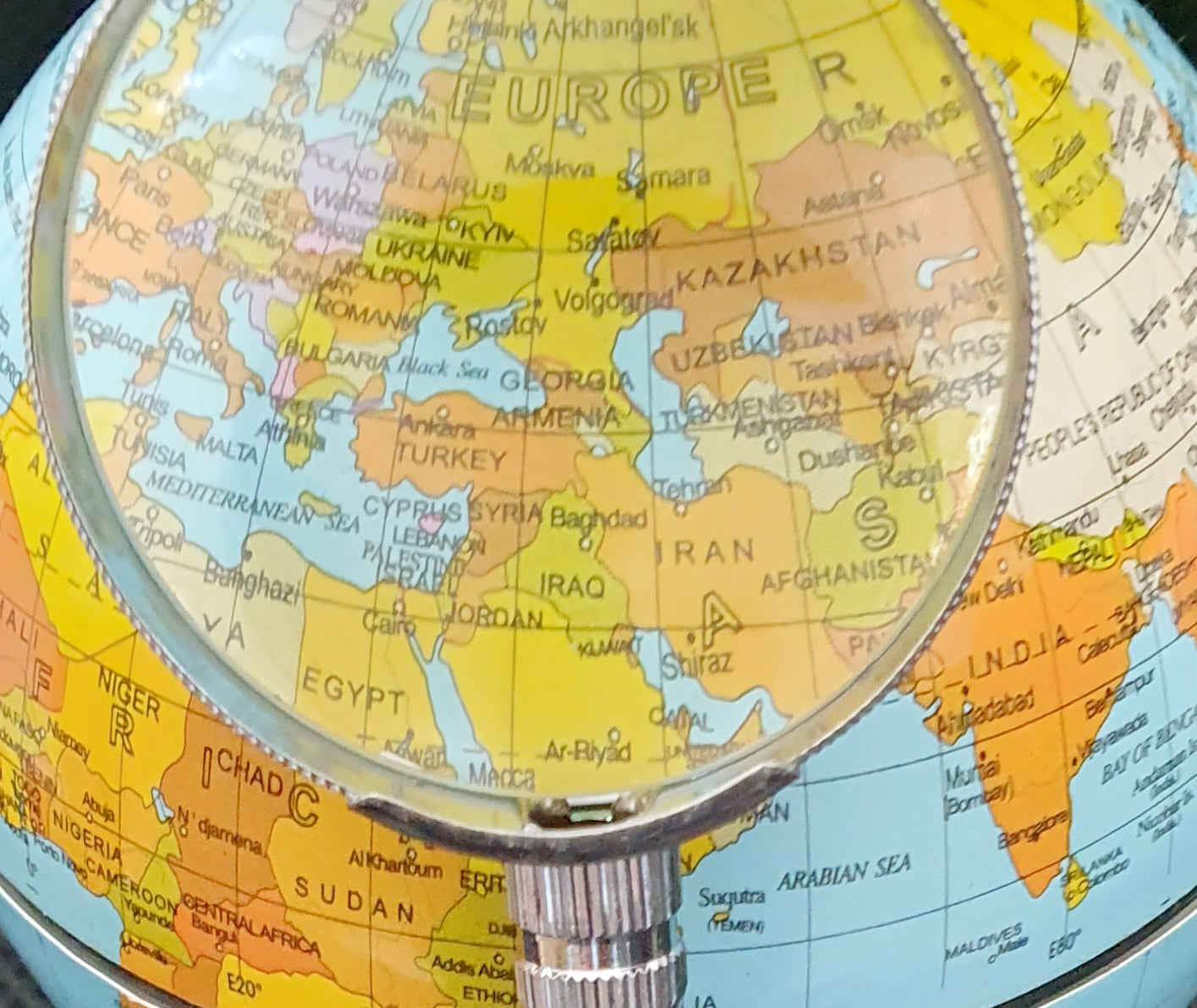 Desktop globe with wooden base and magnifying glass